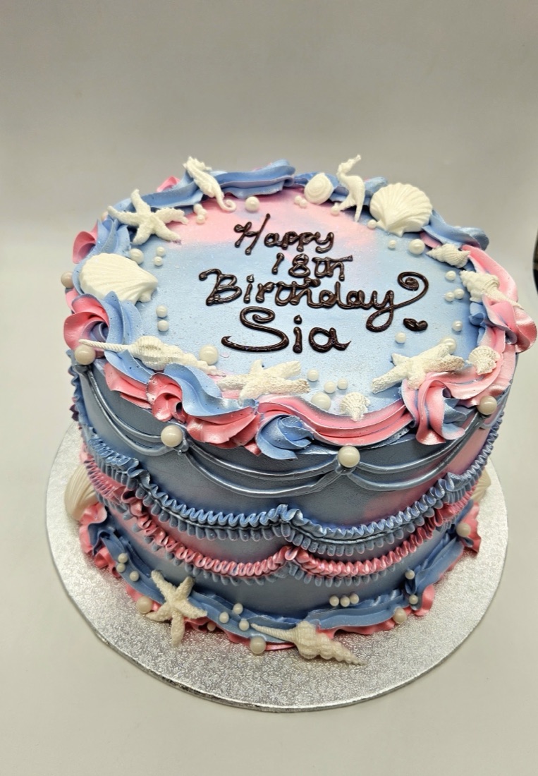 Pink and blue mermaid themed birthday cake with seashells and pearls, by Cakes & Bakes Barkingside