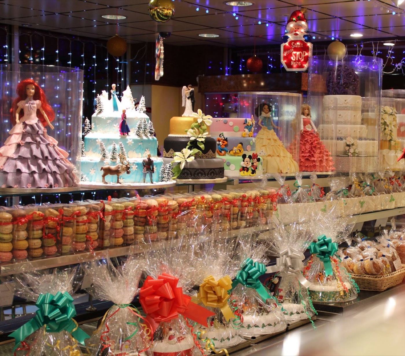 The Cakes & Bakes Barkingside display counter with themed cakes, macarons and gift boxes